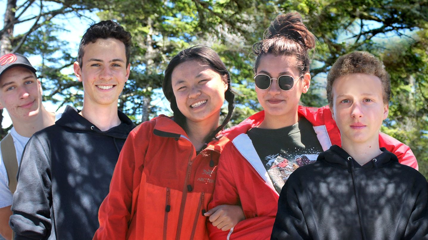 Smiling international students on a hike.
